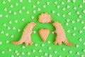 Homemade shortbread cookies decorated white glaze. Two dinosaurs with callout cloud with text Ã¢â¬ËI love youÃ¢â¬â¢ on green background